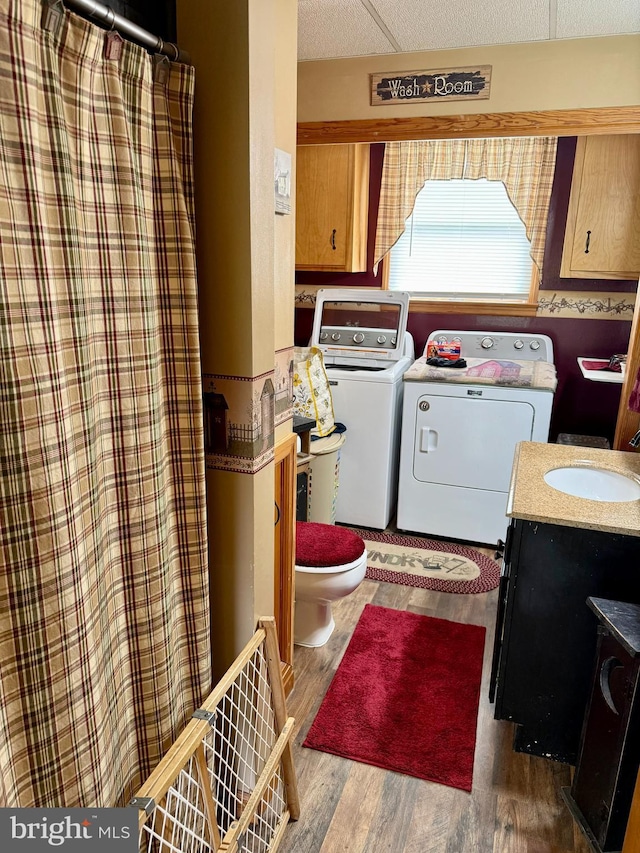 239 S Allison St, Greencastle, PA 17225 - full bathroom with washer and dryer, toilet, wood finished floors, vanity, and a shower with shower curtain