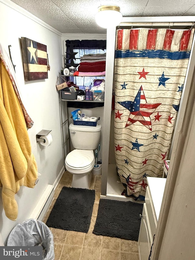239 S Allison St, Greencastle, PA 17225 - bathroom featuring toilet, vanity, baseboard heating, a shower with curtain, and tile patterned flooring