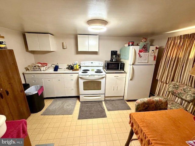 239 S Allison St, Greencastle, PA 17225 - kitchen featuring white appliances, light countertops, white cabinetry, a sink, and light flooring