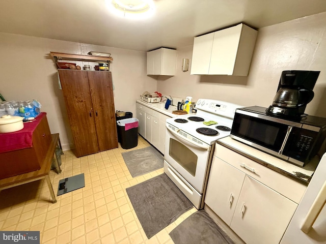 239 S Allison St, Greencastle, PA 17225 - kitchen featuring white electric range oven, stainless steel microwave, light countertops, and white cabinetry