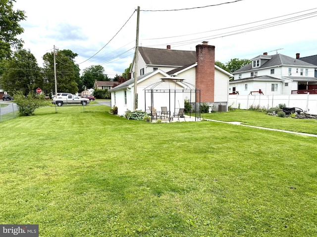 239 S Allison St, Greencastle, PA 17225 - view of property exterior with a gazebo, a chimney, and cooling unit