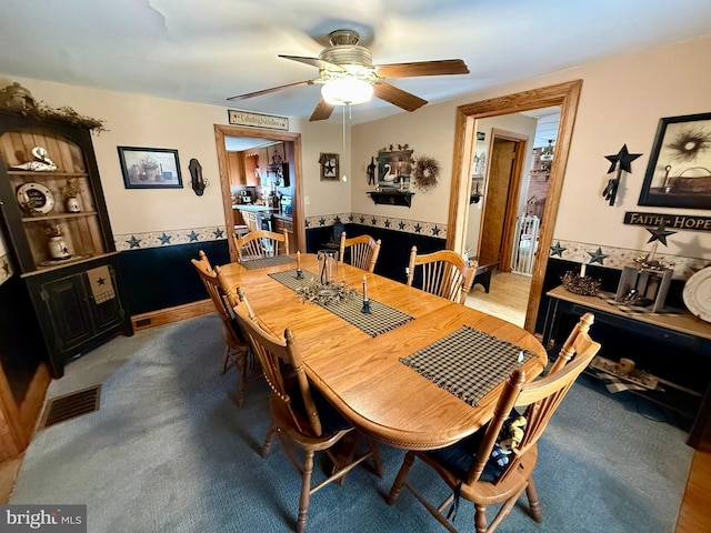 239 S Allison St, Greencastle, PA 17225 - dining space featuring a ceiling fan and a wainscoted wall