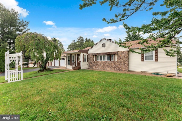 905 Henrietta Ave, Huntingdon Valley, PA 19006 - back of house with a garage, stone siding, a yard, and asphalt driveway