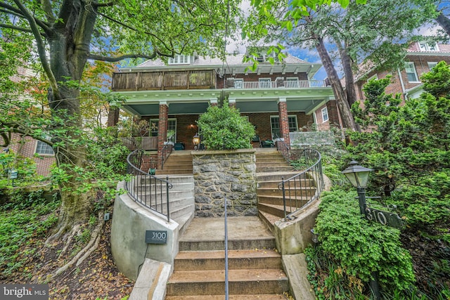 3100 Rodman St NW, Washington, DC 20008 - view of front of house with stairway, covered porch, a balcony, and brick siding
