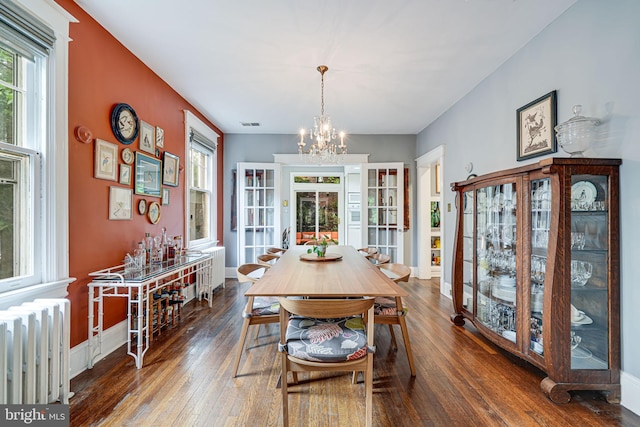 3100 Rodman St NW, Washington, DC 20008 - dining space with radiator, a chandelier, hardwood / wood-style flooring, and baseboards