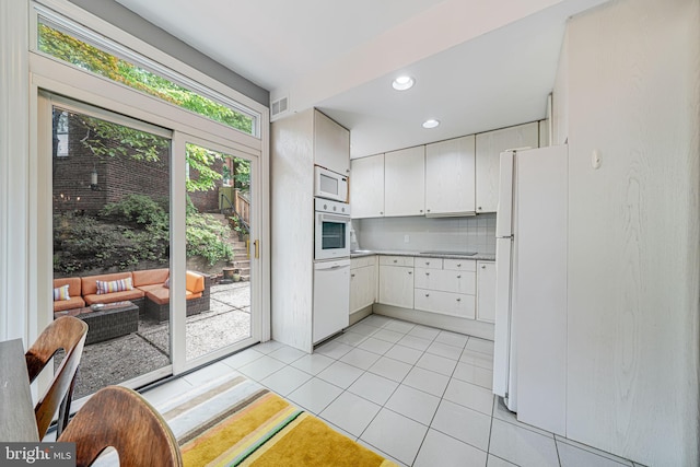3100 Rodman St NW, Washington, DC 20008 - kitchen featuring white appliances, tasteful backsplash, light tile patterned floors, white cabinetry, and recessed lighting