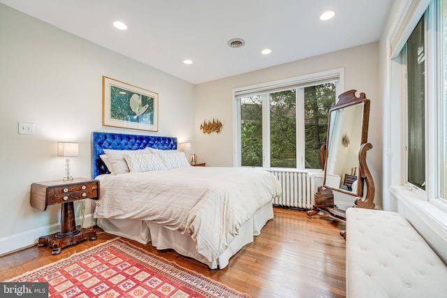 3100 Rodman St NW, Washington, DC 20008 - bedroom featuring radiator heating unit, light wood-style floors, recessed lighting, and baseboards