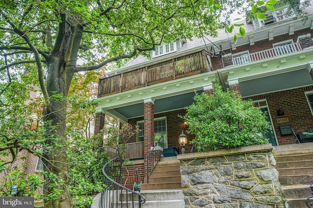 3100 Rodman St NW, Washington, DC 20008 - view of front of home with a porch, stairs, a balcony, and brick siding