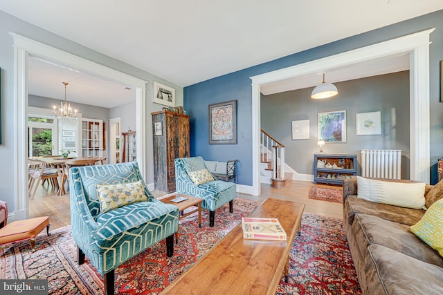 3100 Rodman St NW, Washington, DC 20008 - living area featuring radiator heating unit, wood finished floors, a chandelier, stairway, and baseboards