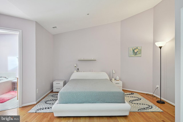 13146 Diamond Hill Dr, Germantown, MD 20874 - bedroom featuring wood finished floors, baseboards, and lofted ceiling
