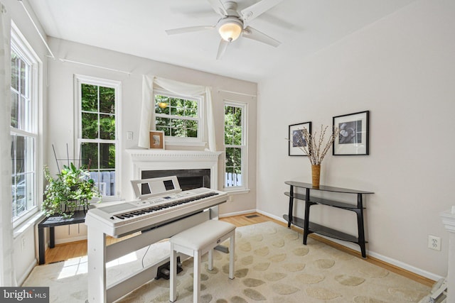 13146 Diamond Hill Dr, Germantown, MD 20874 - sitting room featuring healthy amount of natural light, light wood-type flooring, ceiling fan, and baseboards