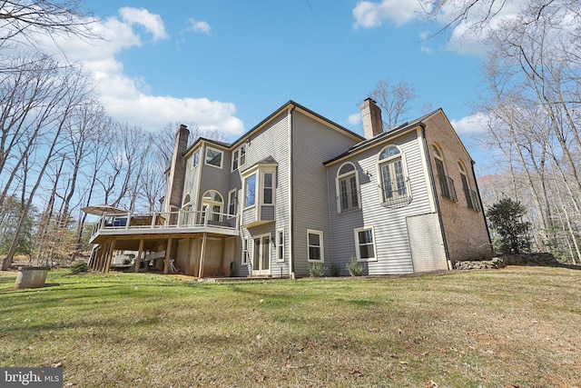 7951 Kelly Ann Ct, Fairfax Station, VA 22039 - back of house featuring a chimney, a wooden deck, and a lawn