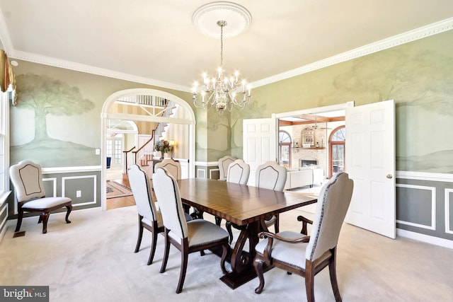 7951 Kelly Ann Ct, Fairfax Station, VA 22039 - dining room featuring a chandelier, ornamental molding, wainscoting, a decorative wall, and arched walkways