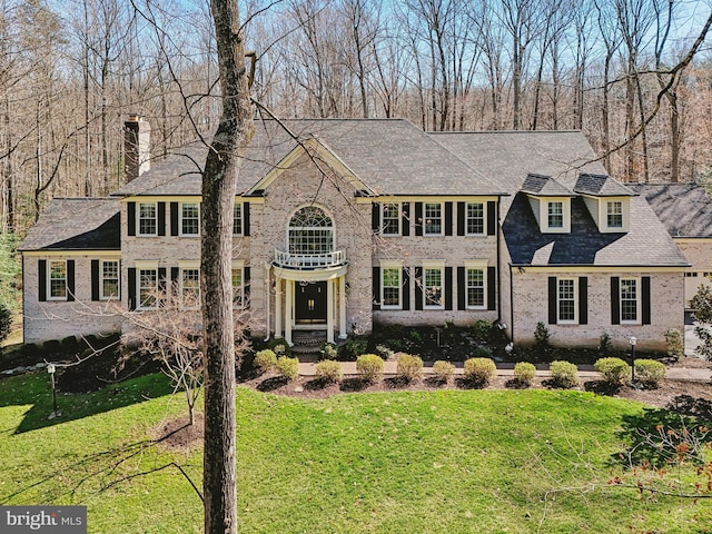 7951 Kelly Ann Ct, Fairfax Station, VA 22039 - georgian-style home with a chimney, a front lawn, and brick siding