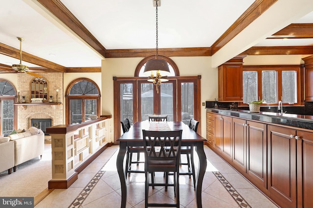 7951 Kelly Ann Ct, Fairfax Station, VA 22039 - dining room featuring inlaid floor details, a chandelier, a ceiling fan, beam ceiling, and a fireplace