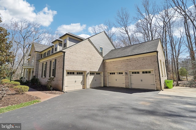 7951 Kelly Ann Ct, Fairfax Station, VA 22039 - view of property exterior with brick siding, asphalt driveway, and a garage