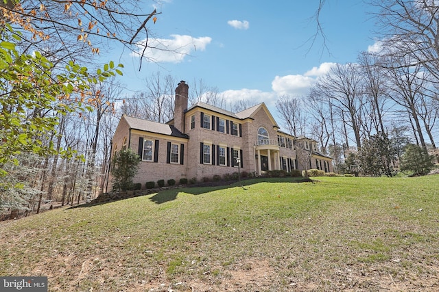 7951 Kelly Ann Ct, Fairfax Station, VA 22039 - rear view of house featuring a chimney, a lawn, and brick siding