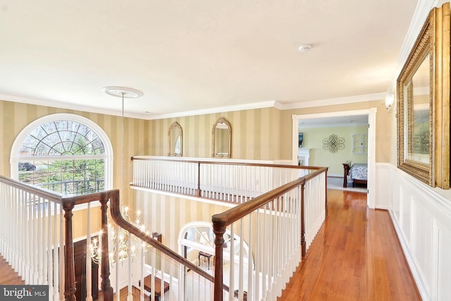 7951 Kelly Ann Ct, Fairfax Station, VA 22039 - hall featuring wallpapered walls, an upstairs landing, wood finished floors, a wainscoted wall, and ornamental molding