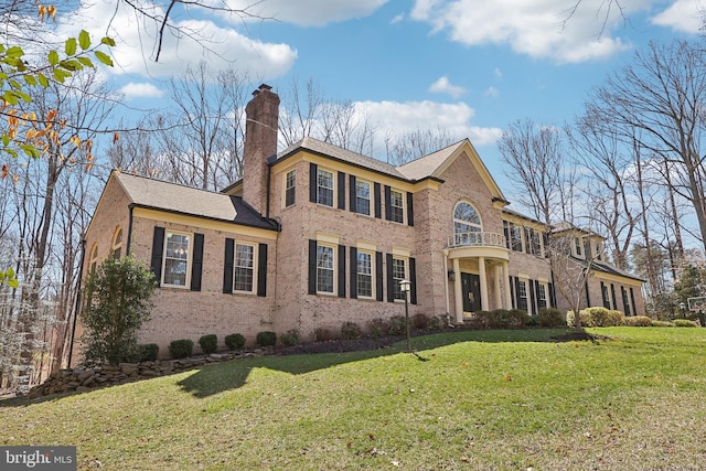 7951 Kelly Ann Ct, Fairfax Station, VA 22039 - colonial house with a chimney, a front yard, and brick siding
