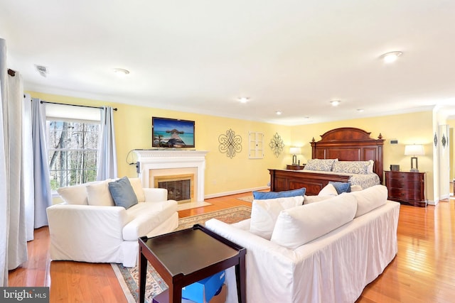 7951 Kelly Ann Ct, Fairfax Station, VA 22039 - living room with a fireplace with flush hearth, light wood finished floors, ornamental molding, and baseboards