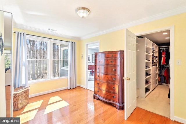 7951 Kelly Ann Ct, Fairfax Station, VA 22039 - bedroom featuring a walk in closet, wood-type flooring, a closet, baseboards, and ornamental molding