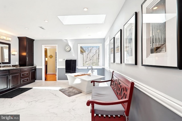 7951 Kelly Ann Ct, Fairfax Station, VA 22039 - full bathroom featuring a soaking tub, vanity, marble finish floors, a skylight, and recessed lighting