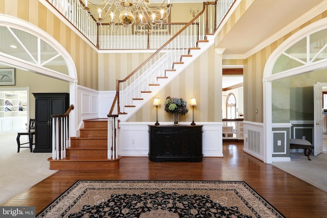 7951 Kelly Ann Ct, Fairfax Station, VA 22039 - stairs with wallpapered walls, wood-type flooring, a decorative wall, a chandelier, and wainscoting