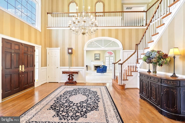 7951 Kelly Ann Ct, Fairfax Station, VA 22039 - entryway with wallpapered walls, stairway, hardwood / wood-style floors, healthy amount of natural light, and a chandelier