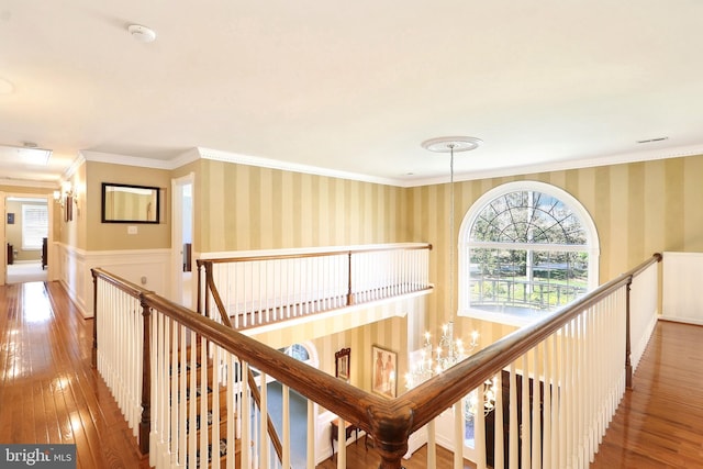 7951 Kelly Ann Ct, Fairfax Station, VA 22039 - hallway featuring an upstairs landing, wood-type flooring, wallpapered walls, ornamental molding, and wainscoting