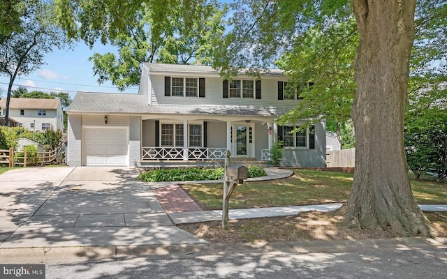 13 Barnard St, Newark, DE 19711 - view of front of home with covered porch, a garage, concrete driveway, and brick siding