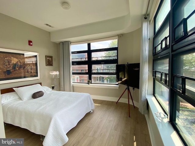 1111 Orren St NE Unit 300, Washington, DC 20002 - bedroom featuring baseboards and wood finished floors