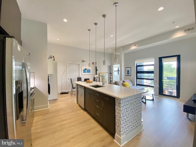 1111 Orren St NE Unit 300, Washington, DC 20002 - kitchen with appliances with stainless steel finishes, a sink, light countertops, modern cabinets, and light wood-style floors