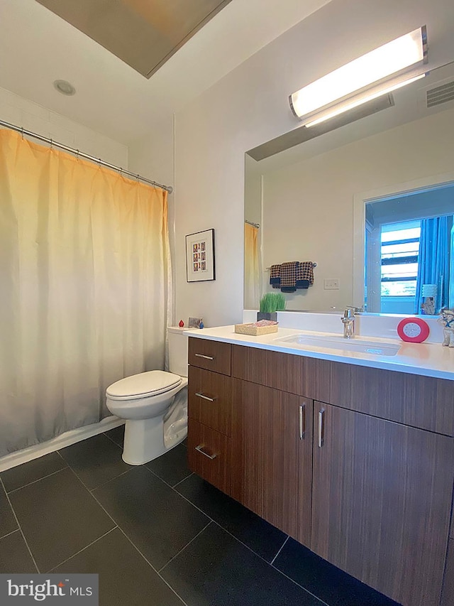 1111 Orren St NE Unit 300, Washington, DC 20002 - bathroom featuring vanity, toilet, tile patterned flooring, and a shower with shower curtain