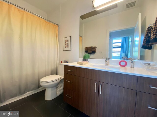 1111 Orren St NE Unit 300, Washington, DC 20002 - full bath featuring vanity, tile patterned flooring, toilet, and a shower with curtain
