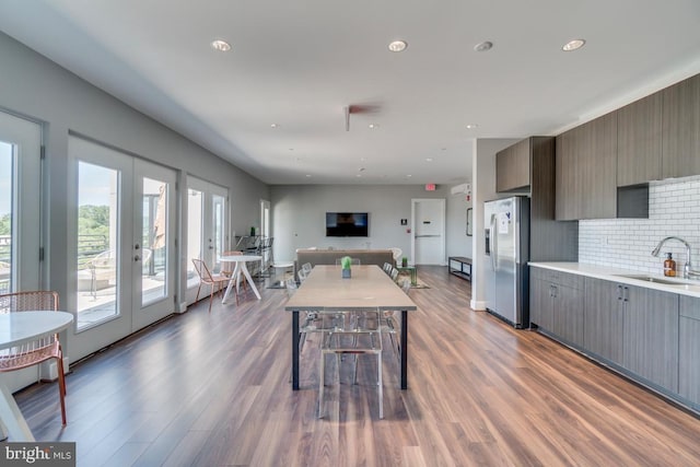 1111 Orren St NE Unit 300, Washington, DC 20002 - kitchen featuring stainless steel fridge, a sink, french doors, wood finished floors, and backsplash