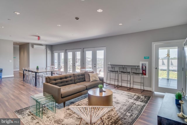 1111 Orren St NE Unit 300, Washington, DC 20002 - living area featuring baseboards, an AC wall unit, wood finished floors, french doors, and recessed lighting