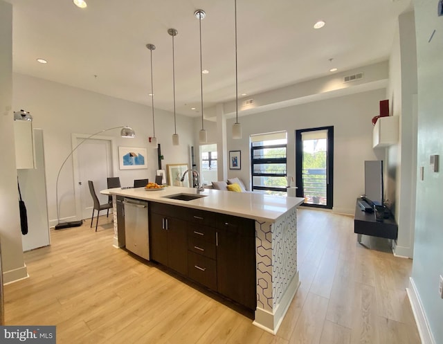 1111 Orren St NE Unit 300, Washington, DC 20002 - kitchen with stainless steel dishwasher, a sink, light wood-style flooring, dark brown cabinets, and recessed lighting