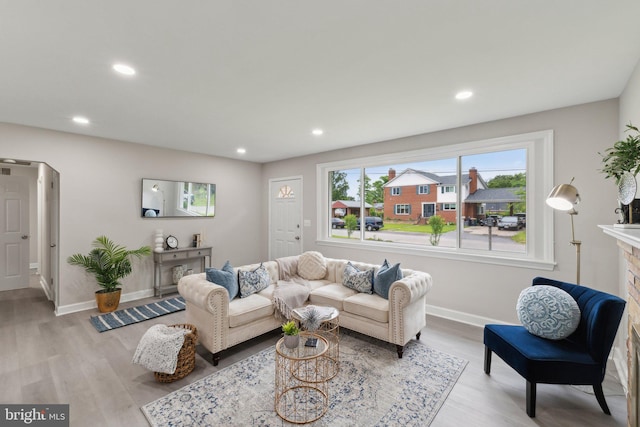 3015 Logan St, District Heights, MD 20747 - living room featuring baseboards, recessed lighting, light wood-style flooring, and a fireplace
