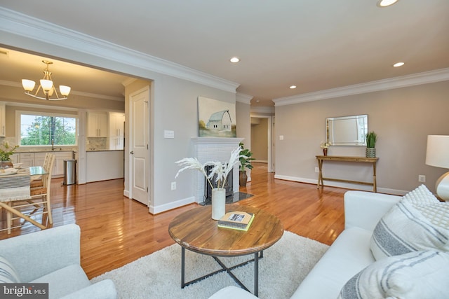 6823 Donahue Ct, Falls Church, VA 22042 - living room featuring a chandelier, a brick fireplace, crown molding, recessed lighting, and light wood-style flooring