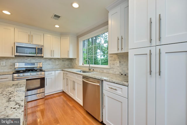 6823 Donahue Ct, Falls Church, VA 22042 - kitchen with stainless steel appliances, a sink, white cabinetry, recessed lighting, and decorative backsplash