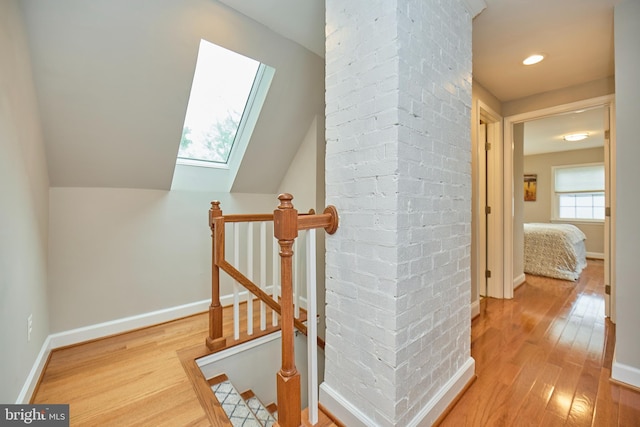 6823 Donahue Ct, Falls Church, VA 22042 - staircase featuring a skylight, hardwood / wood-style floors, baseboards, and lofted ceiling