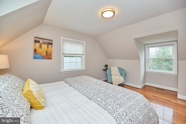 6823 Donahue Ct, Falls Church, VA 22042 - bedroom with vaulted ceiling, multiple windows, wood finished floors, and baseboards