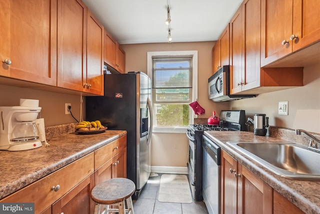 4402 1st Pl NE Unit 11, Washington, DC 20011 - kitchen with a sink, appliances with stainless steel finishes, brown cabinetry, and baseboards