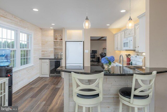 347 Paulsboro Rd, Woolwich Twp, NJ 08085 - kitchen with beverage cooler, white appliances, dark countertops, a peninsula, and decorative light fixtures