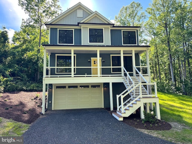 2655 5th St, Owings, MD 20736 - view of front of home featuring a garage, board and batten siding, asphalt driveway, a porch, and stairs