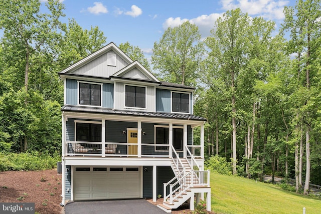 2655 5th St, Owings, MD 20736 - view of front facade with a standing seam roof, a porch, stairs, driveway, and a front yard