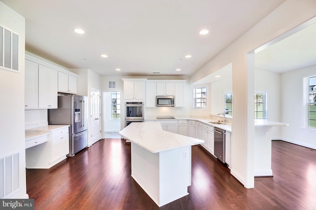 15491 Barnesville Rd, Boyds, MD 20841 - kitchen with stainless steel appliances, a sink, dark wood finished floors, white cabinetry, and recessed lighting