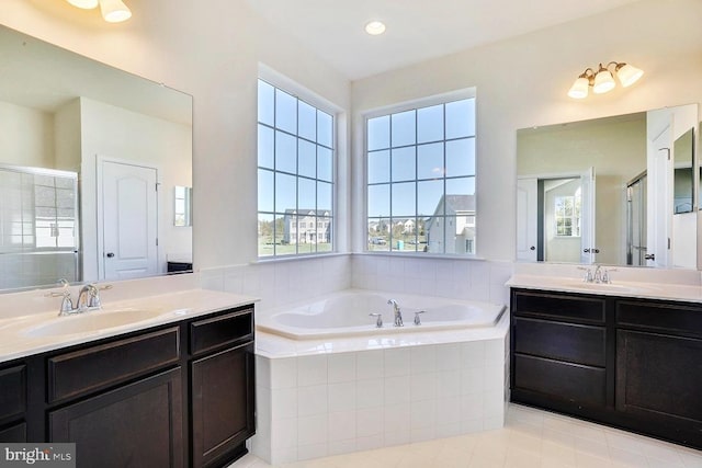 15491 Barnesville Rd, Boyds, MD 20841 - bathroom featuring two vanities, a garden tub, and healthy amount of natural light