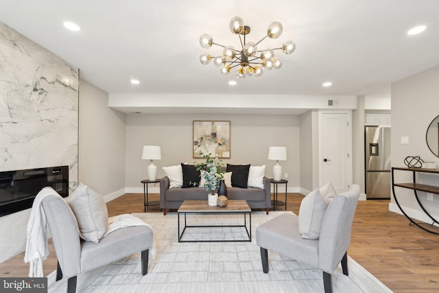 4536 Conwell Dr, Annandale, VA 22003 - living area with recessed lighting, light wood-type flooring, a chandelier, baseboards, and a fireplace