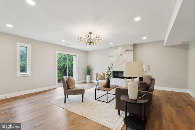 4536 Conwell Dr, Annandale, VA 22003 - living room with recessed lighting, baseboards, wood finished floors, a chandelier, and a premium fireplace